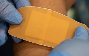  Nurse putting on band-aid